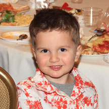 Photo of a young boy wearing floral polo shirt