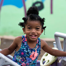 photo of a young girl wearing floral sleeveless shirt