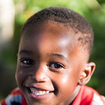 photo of an african american boy smiling at the camera