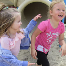 photo of two girls playing at the park